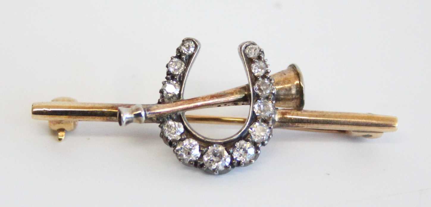 A circa 1900 yellow metal diamond set hunting brooch, arranged as a horseshoe and post-hunt horn, - Image 2 of 3