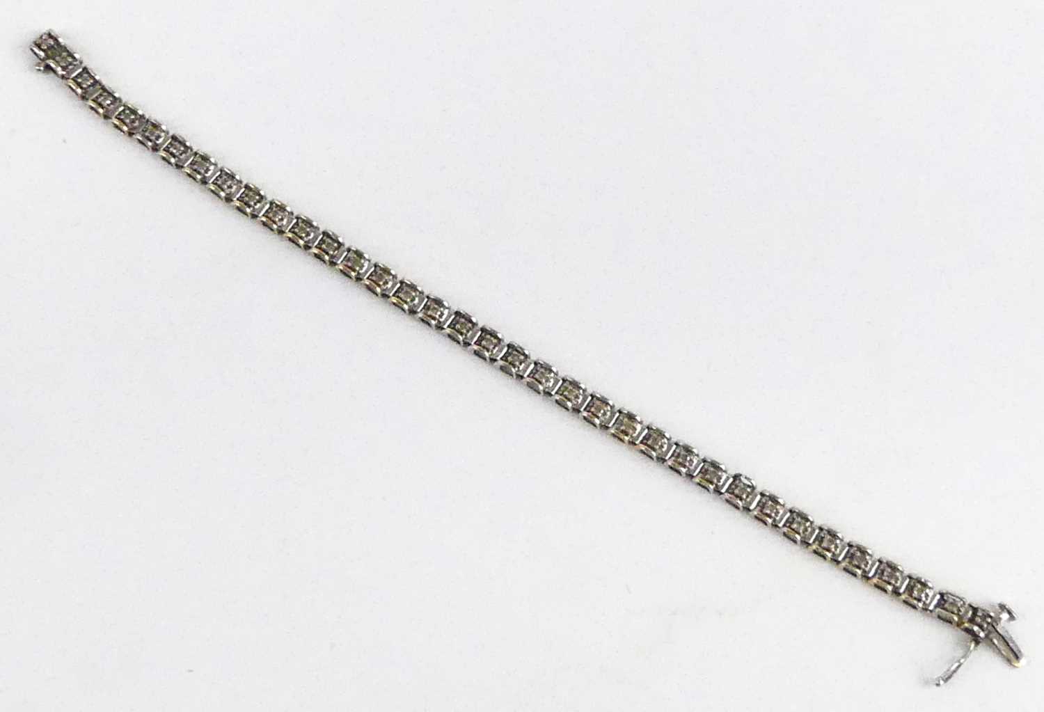 A 9ct white gold diamond tennis style bracelet, having box clasp and figure-of-eight safety catch, - Image 3 of 5