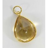 A yellow metal citrine pendant, having a pear cut citrine in a bezel setting, citrine dimensions