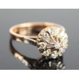 A rose and white metal diamond target style cluster ring, featuring a centre round brilliant cut