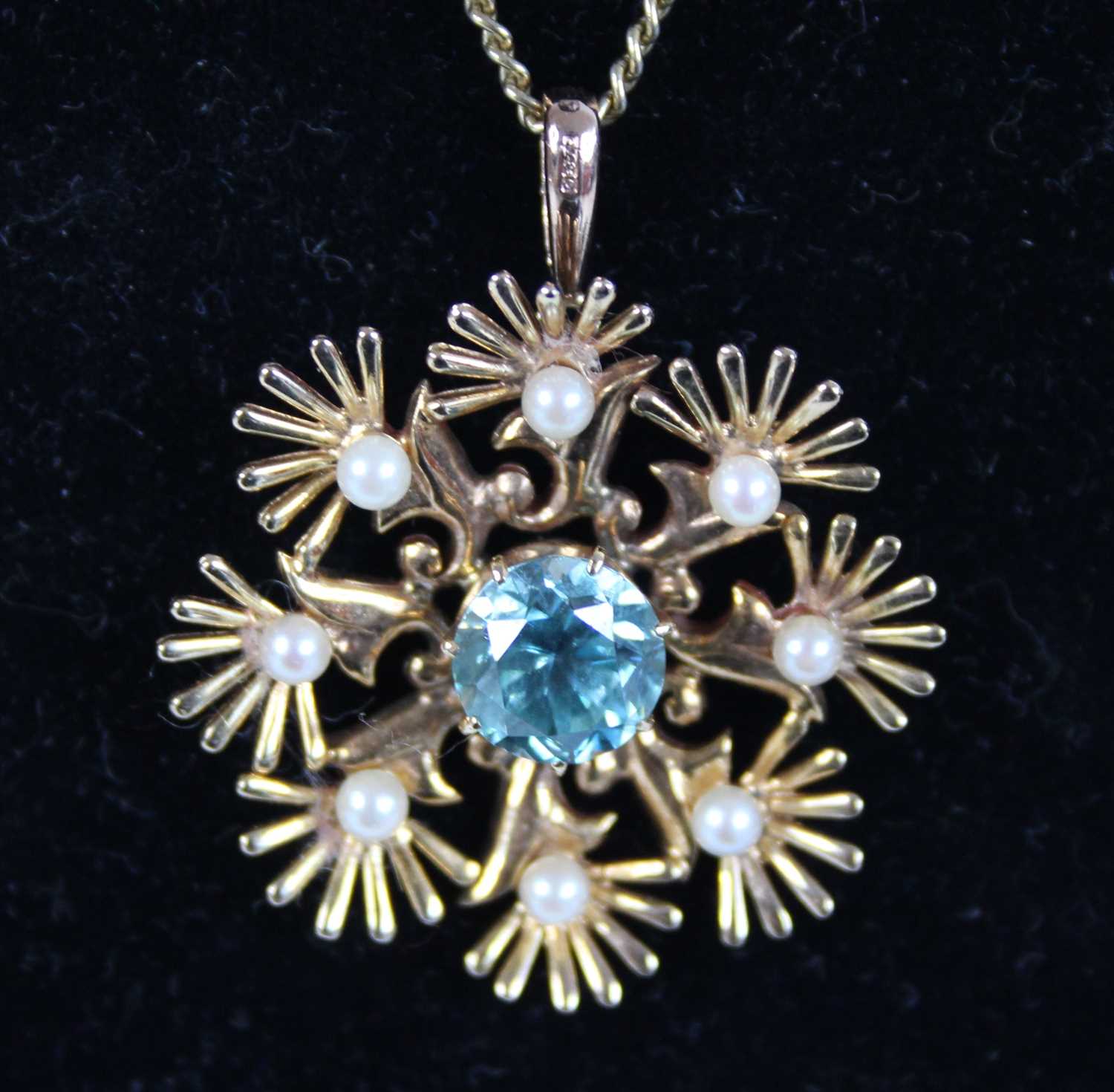 A 9ct yellow gold, zircon and pearl eight-ray star pendant, the centre round zircon measuring approx - Image 2 of 4