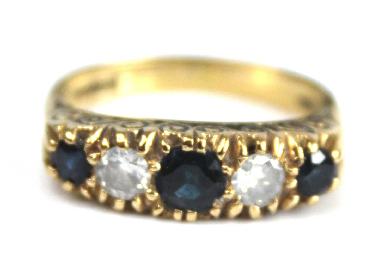 An 18ct yellow gold, sapphire and diamond half eternity ring, comprising three graduated round