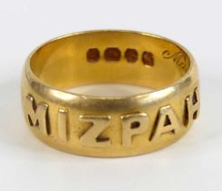 A late Victorian 18ct yellow gold ring, with Mizpah in raised lettering around the outside from