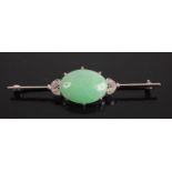 A white metal, jade and diamond knife-edge bar brooch, the cabochon celadon jade measuring 19 x 18.1