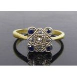 A yellow and white metal, sapphire and diamond quatrefoil cluster ring, featuring a centre Old