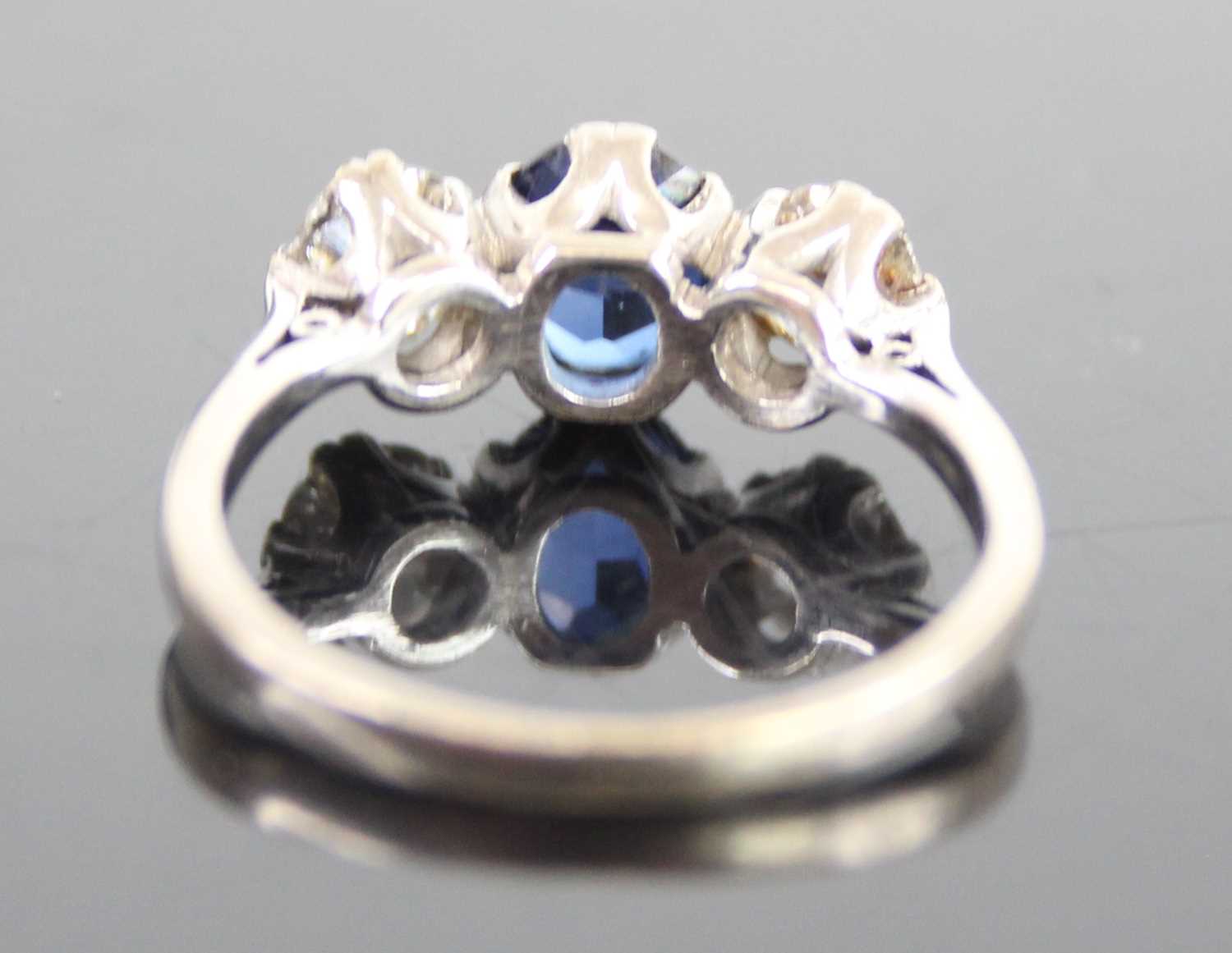 A white metal, sapphire and diamond three-stone ring, featuring a centre oval sapphire with an Old - Image 4 of 7