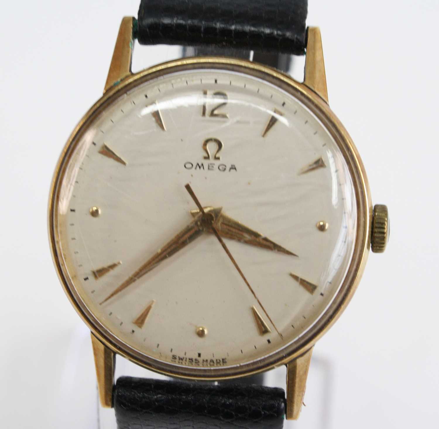 A 14ct yellow gold vintage Omega manual wind wristwatch, having a round cream baton dial and