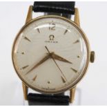 A 14ct yellow gold vintage Omega manual wind wristwatch, having a round cream baton dial and