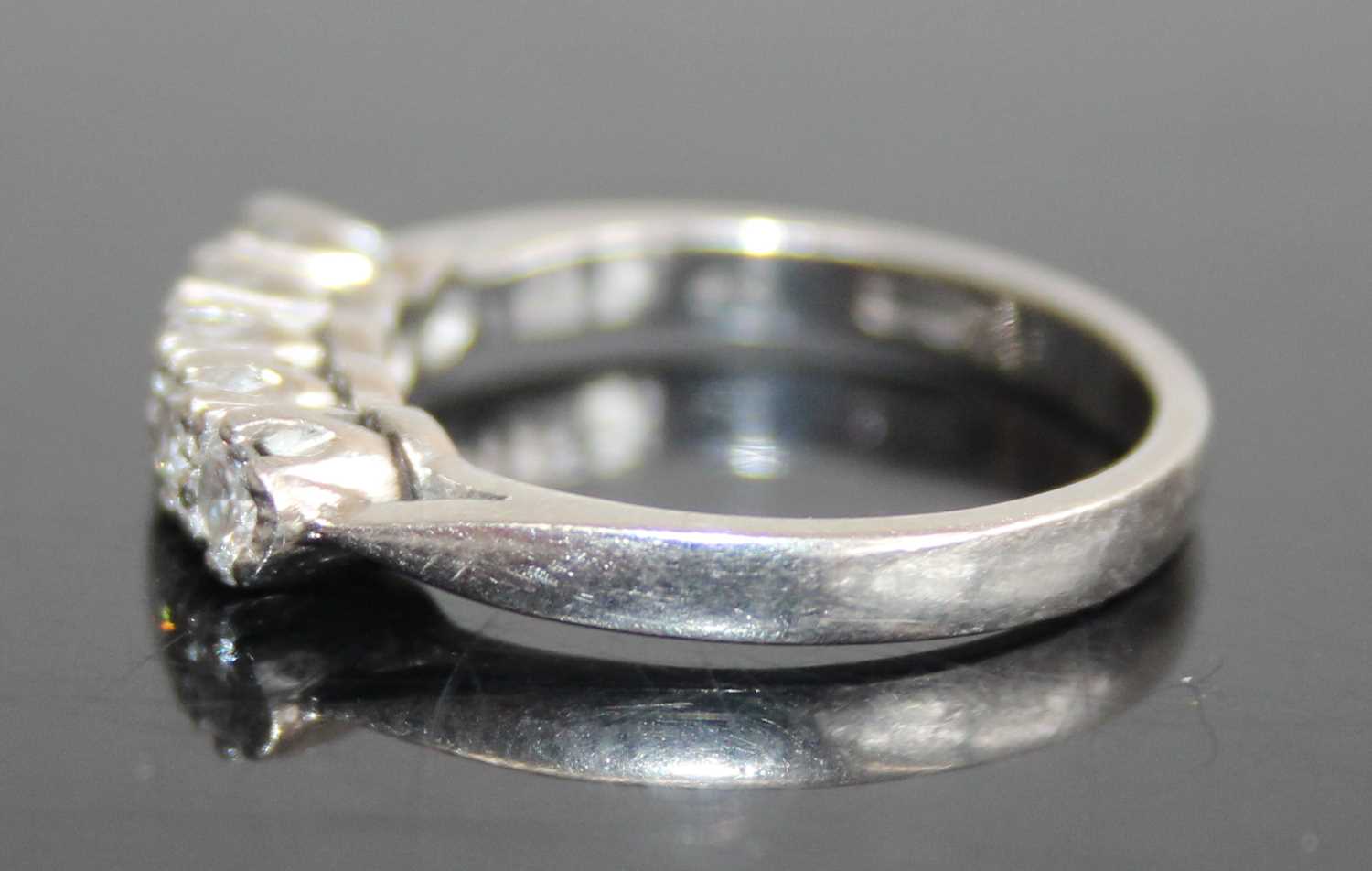 A platinum diamond half hoop ring, arranged as five claw set brilliants in a line setting, total - Image 4 of 5