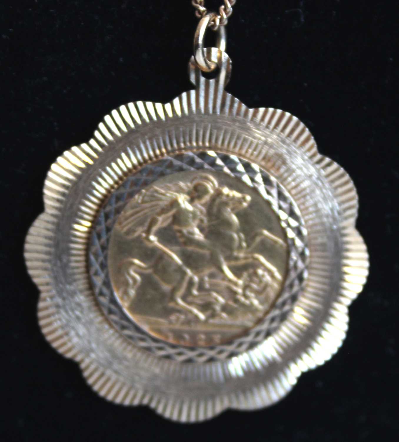 A George V gold half sovereign, 1925, in 9ct gold pendant mount and on 9ct gold fine curblink neck