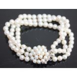 A cultured pearl three-string bracelet, the strung knotted pearls each approx dia.5.2 - 5.4mm, to