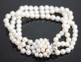 A cultured pearl three-string bracelet, the strung knotted pearls each approx dia.5.2 - 5.4mm, to