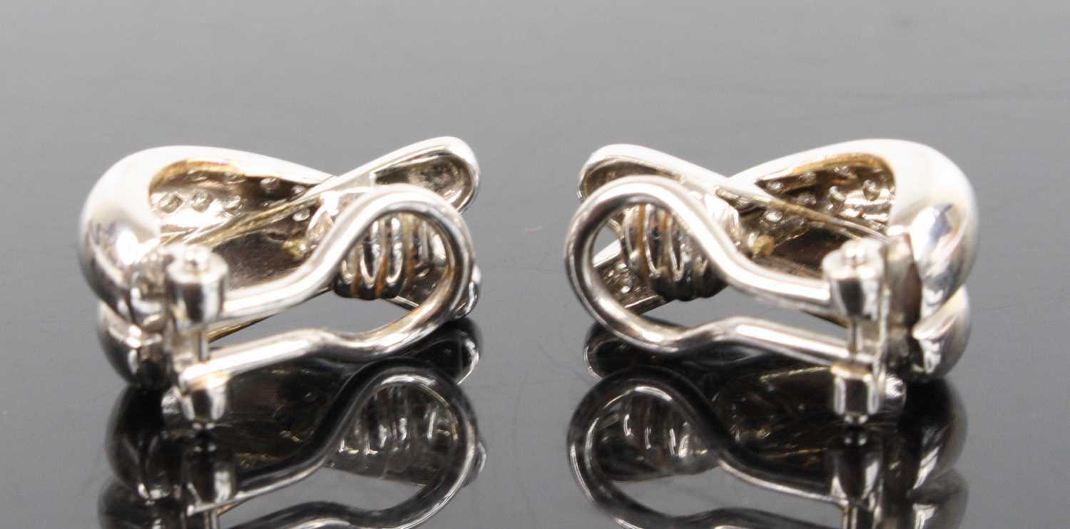 A pair of 18ct white gold diamond two-strand crossover clip earrings, each comprising a strand of 21 - Image 3 of 4