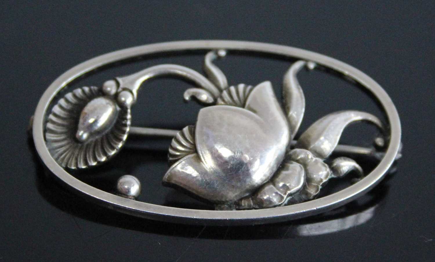 A 1940's Georg Jensen sterling silver floral brooch by Gundorph Albertus, comprising a stylised