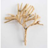 A yellow metal diamond set brooch, in the form of textured branches with three Old European cut