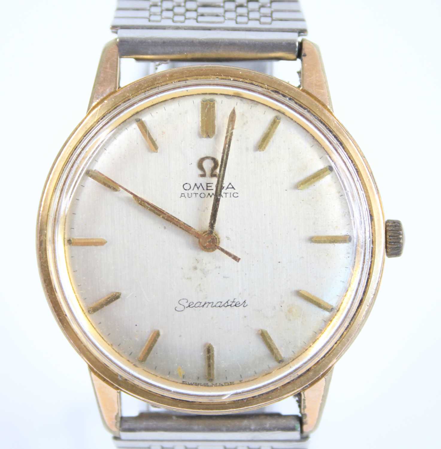 A gents Omega Seamaster bi-metal automatic wristwatch, having silvered baton dial and non-related