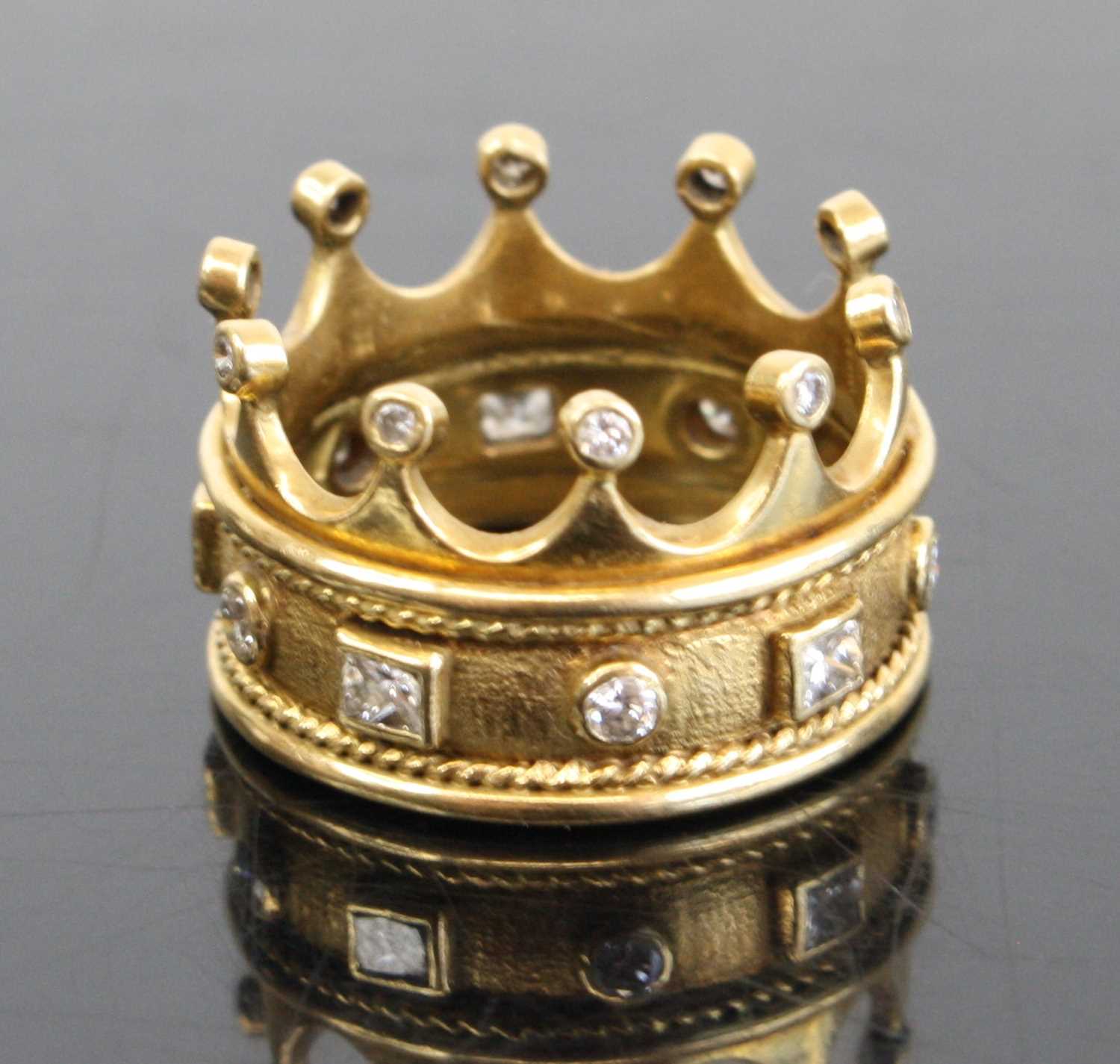 A contemporary Arts & Crafts yellow metal and diamond set ring fashioned as a crown, the 7mm band - Image 2 of 4