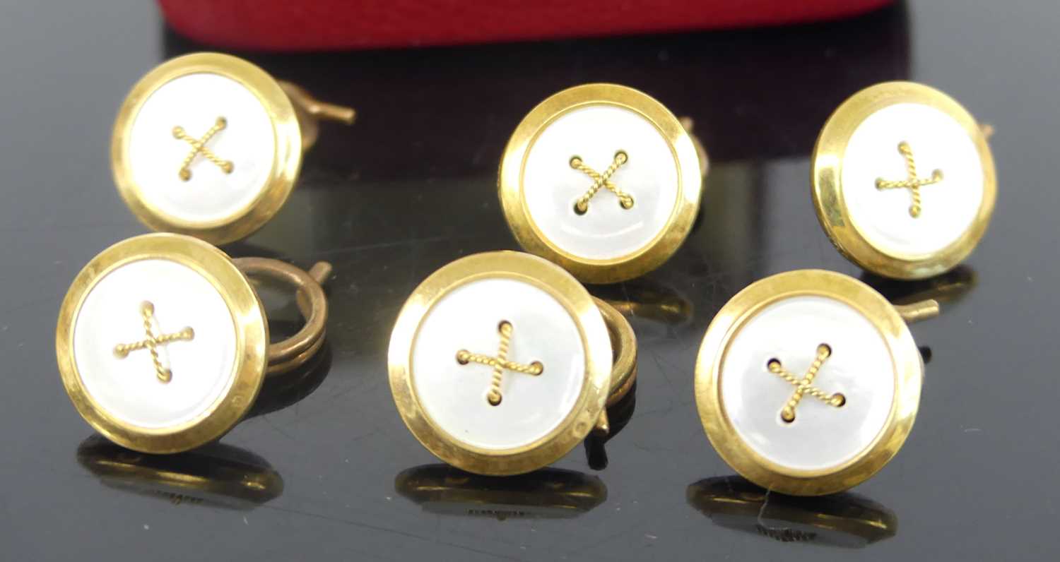 A set of six yellow metal circular dress studs, with mother of pearl inlay and cross detail to the