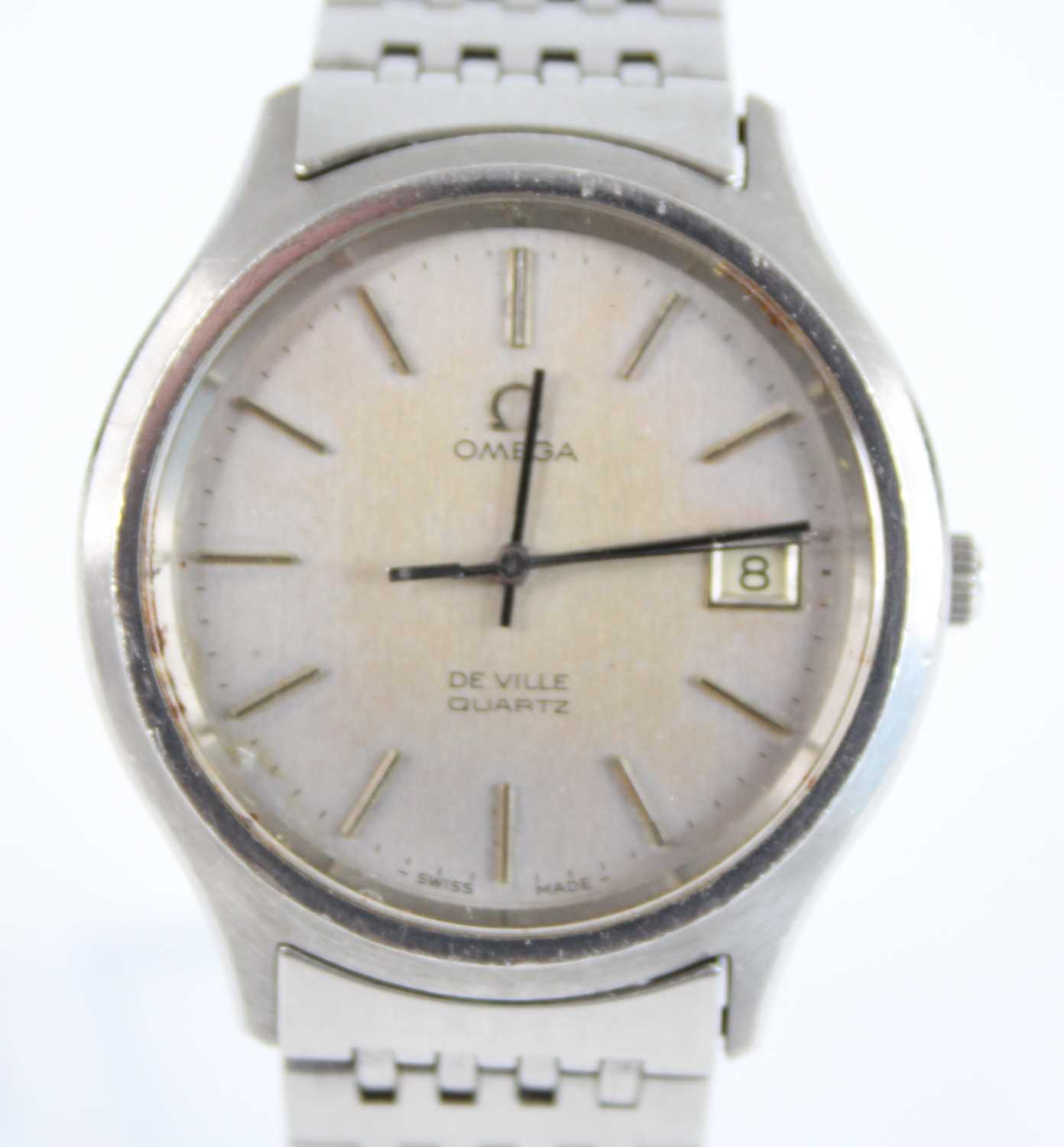 A steel Omega DeVille quartz wristwatch, with round silver baton dial and date at 3, fitted to a bar