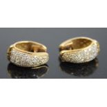 A pair of yellow metal diamond hinged huggy hoop earrings, each with 33 round brilliant cut diamonds