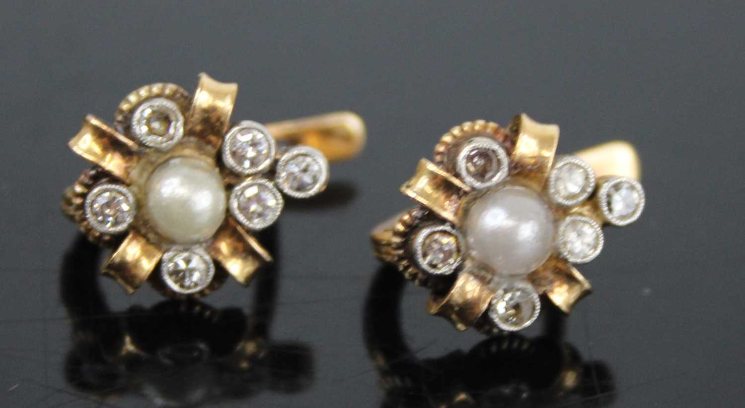 A pair of Victorian yellow metal, seed pearl and diamond set ear studs, on post fittings, arranged