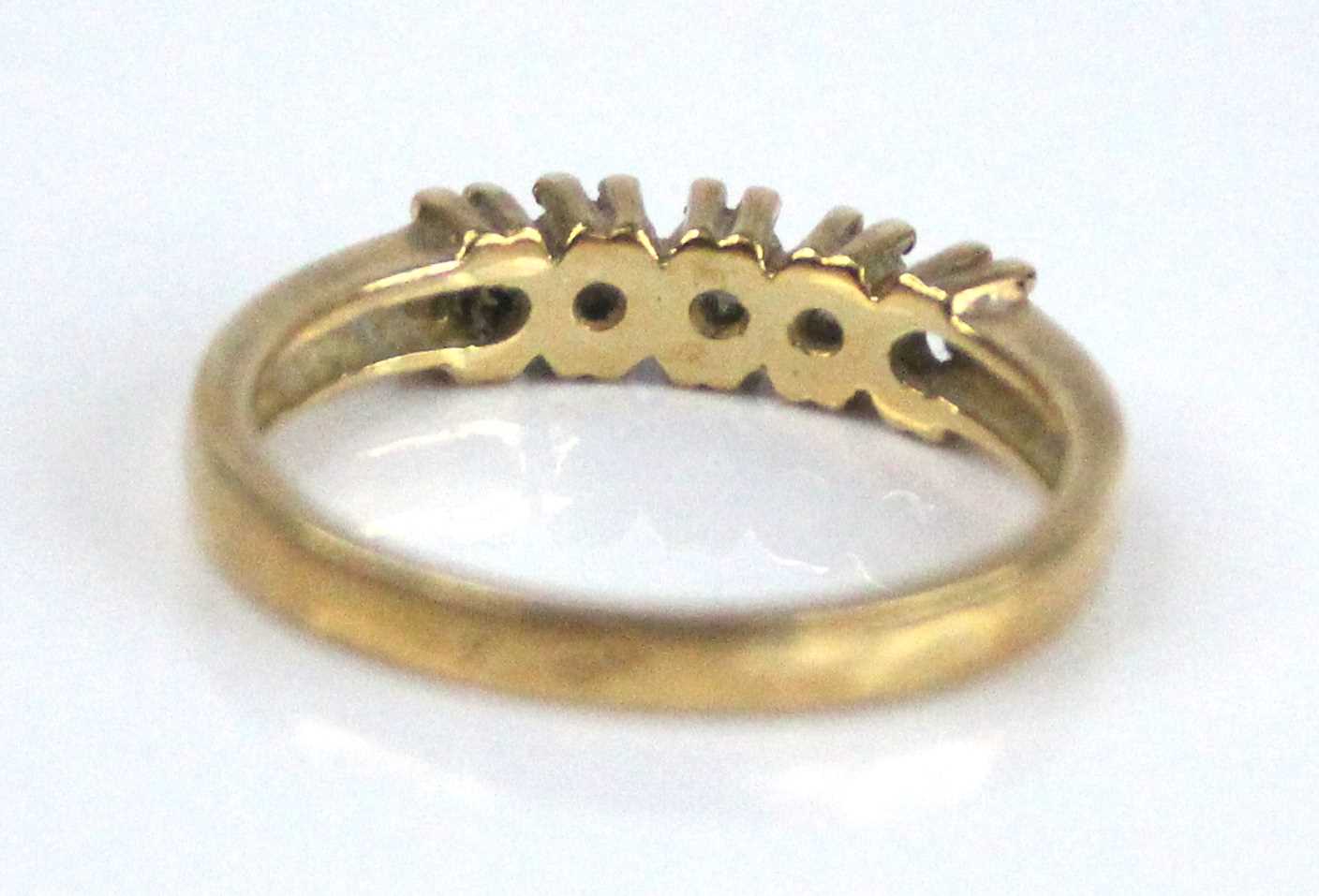 A yellow metal diamond half eternity ring, having five round brilliant cut diamonds in claw - Image 3 of 6