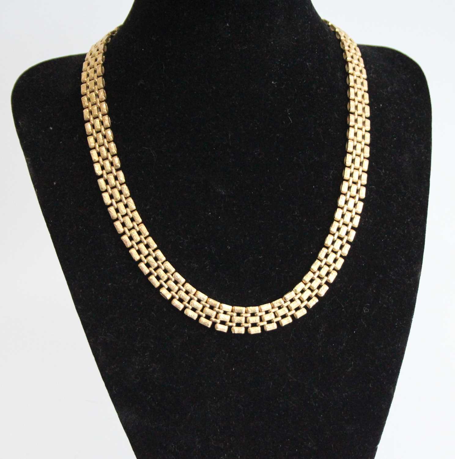 A 9ct heavy gold triple row choker, each link with raised and chased decoration, 45g, length 42cm