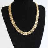 A 9ct heavy gold triple row choker, each link with raised and chased decoration, 45g, length 42cm