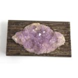 A circa 1970s white metal and amethyst geode set brooch, the white metal mount with reeded bands,