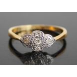 An Art Deco 18ct gold and platinum diamond set ring, the shaped oval tablet pavé set with five round