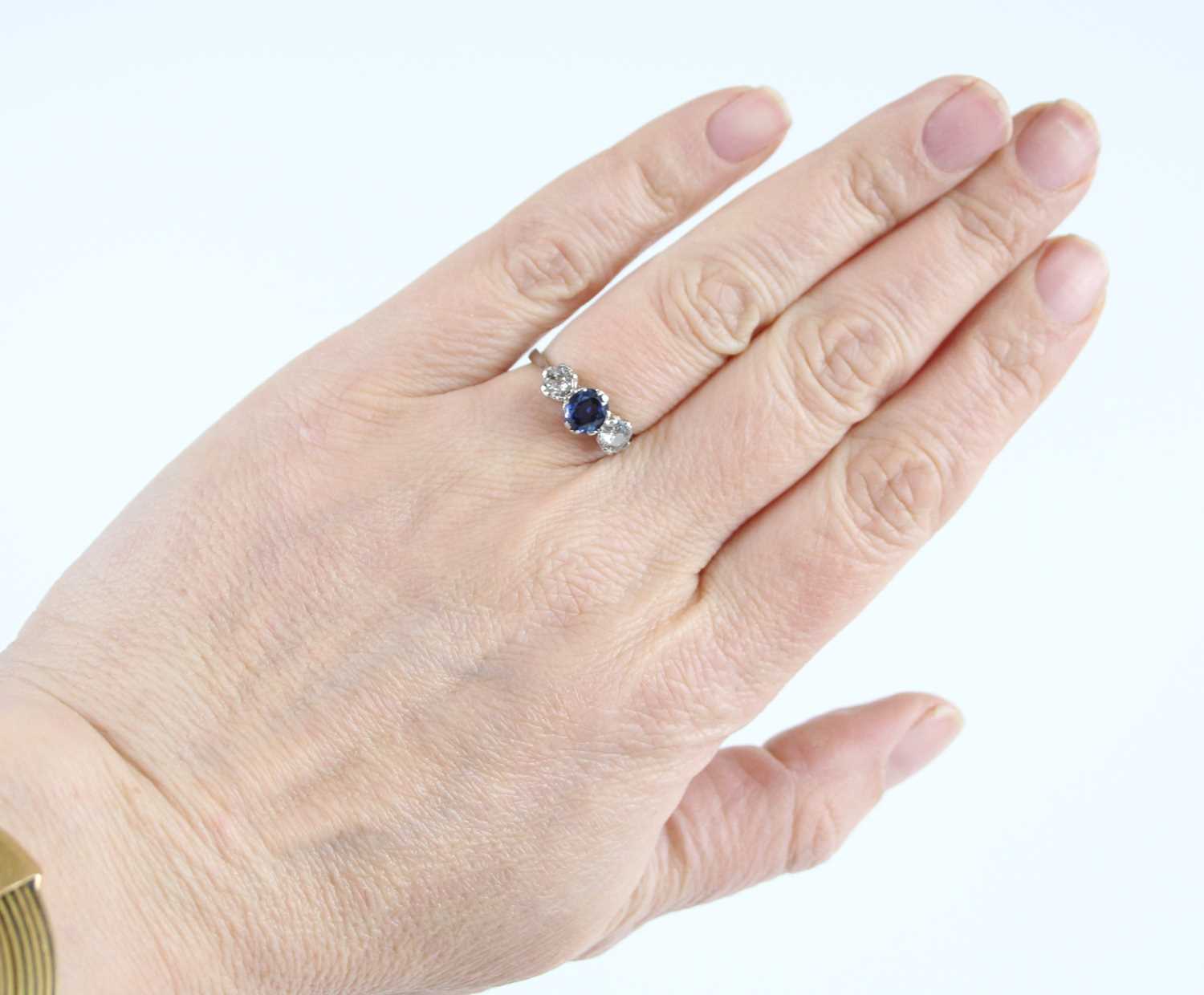 A white metal, sapphire and diamond three-stone ring, featuring a centre oval sapphire with an Old - Image 7 of 7
