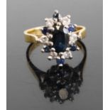 A modern 18ct gold sapphire and diamond flowerhead cluster ring, arranged as a centre oval cut
