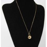A modern 14ct gold ball pendant, dia.15mm, on finelink gold neck chain, 4.1g