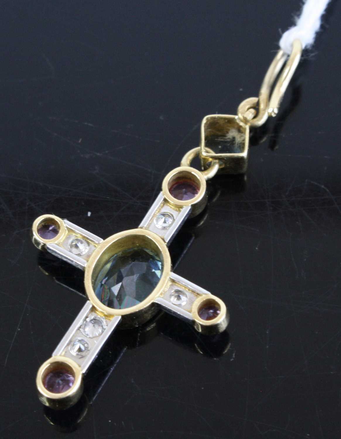 A contemporary yellow & white metal multi-stone set cross pendant, centre set with an oval cut - Image 3 of 3