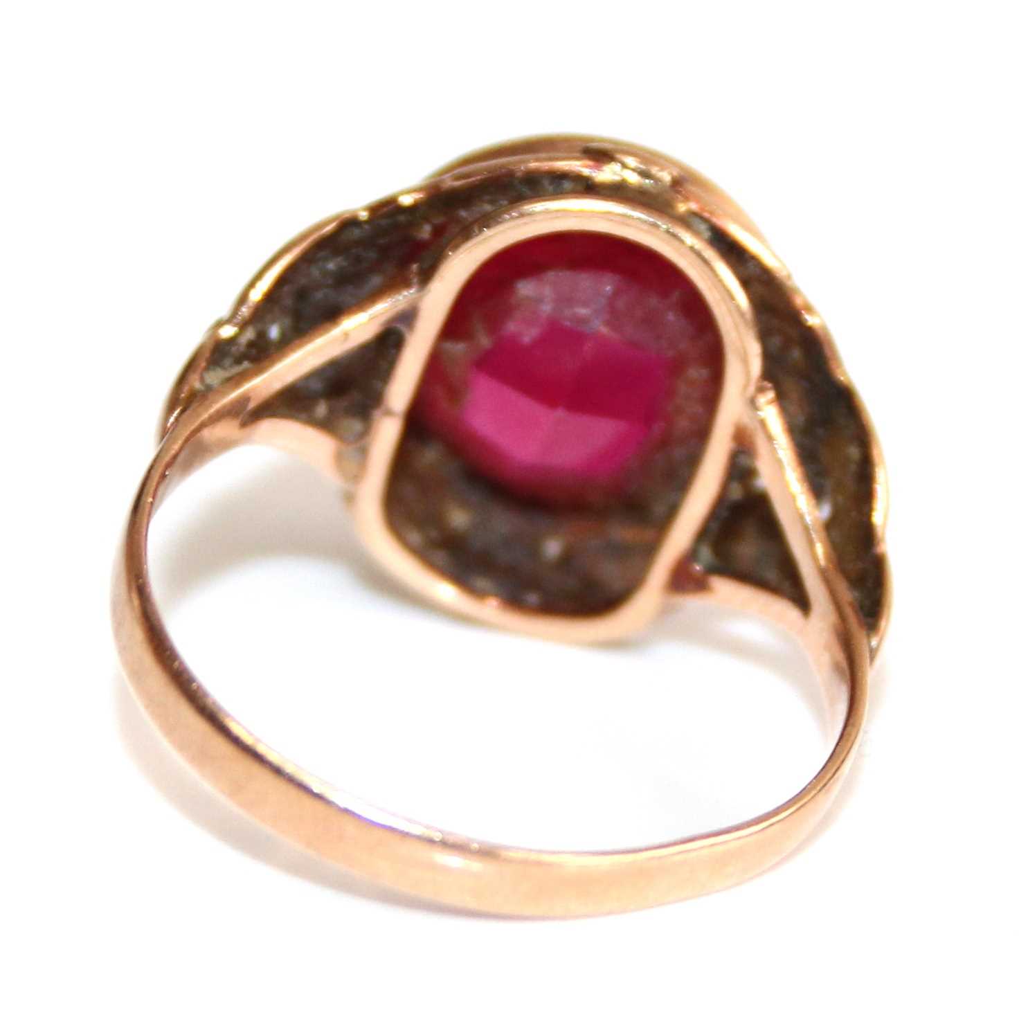 A yellow metal and synthetic ruby set dress ring, the large round cut red stone measuring approx - Image 3 of 6