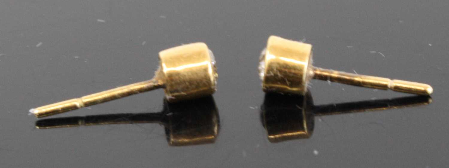 A pair of yellow metal diamond ear studs, the bezel set round cut diamonds each dia. approx 3.6mm - Image 3 of 3