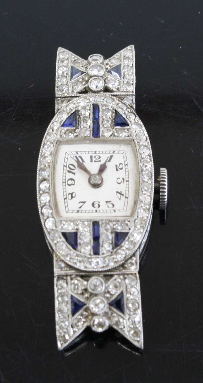 An Art Deco platinum sapphire and diamond set cocktail watch having a signed silvered Arabic dial