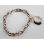 A modern silver chain link bracelet 19cm, together with a modern silver dress ring, size K, gross