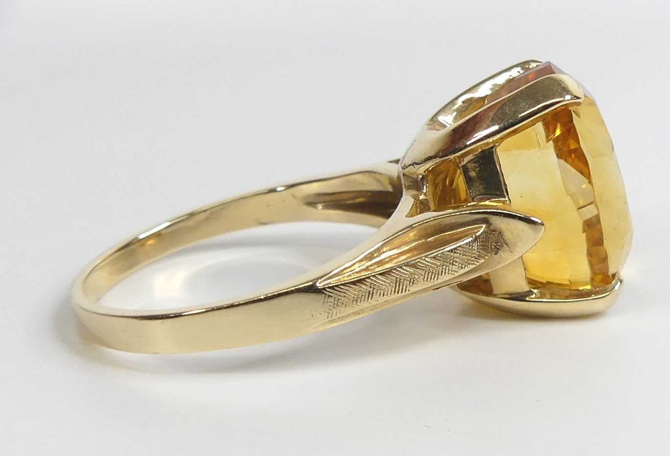 A yellow metal citrine single stone ring, featuring an oval citrine in a four-claw setting with - Image 3 of 7