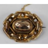 A Victorian yellow metal boss shape oval brooch, with chain link border, having steel pin and safety