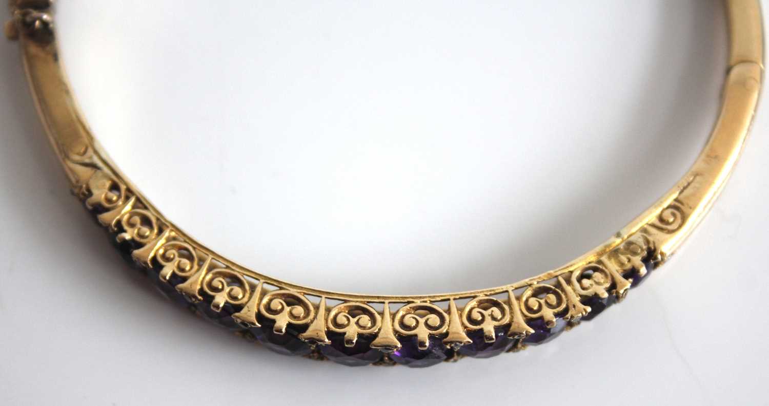 A yellow metal, amethyst and diamond point set hinged bangle, arranged as eleven graduated round cut - Image 3 of 4