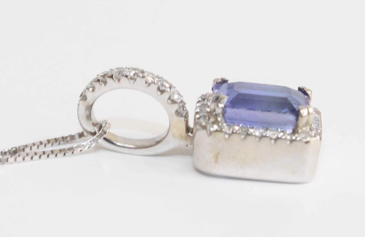 A white metal, tanzanite and diamond rectangular cluster pendant, featuring a centre step-cut - Image 5 of 5