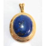 An 18ct yellow gold and lapis lazuli pendant, the cabochon stone measuring approx 17 x 14.4 x 7mm,