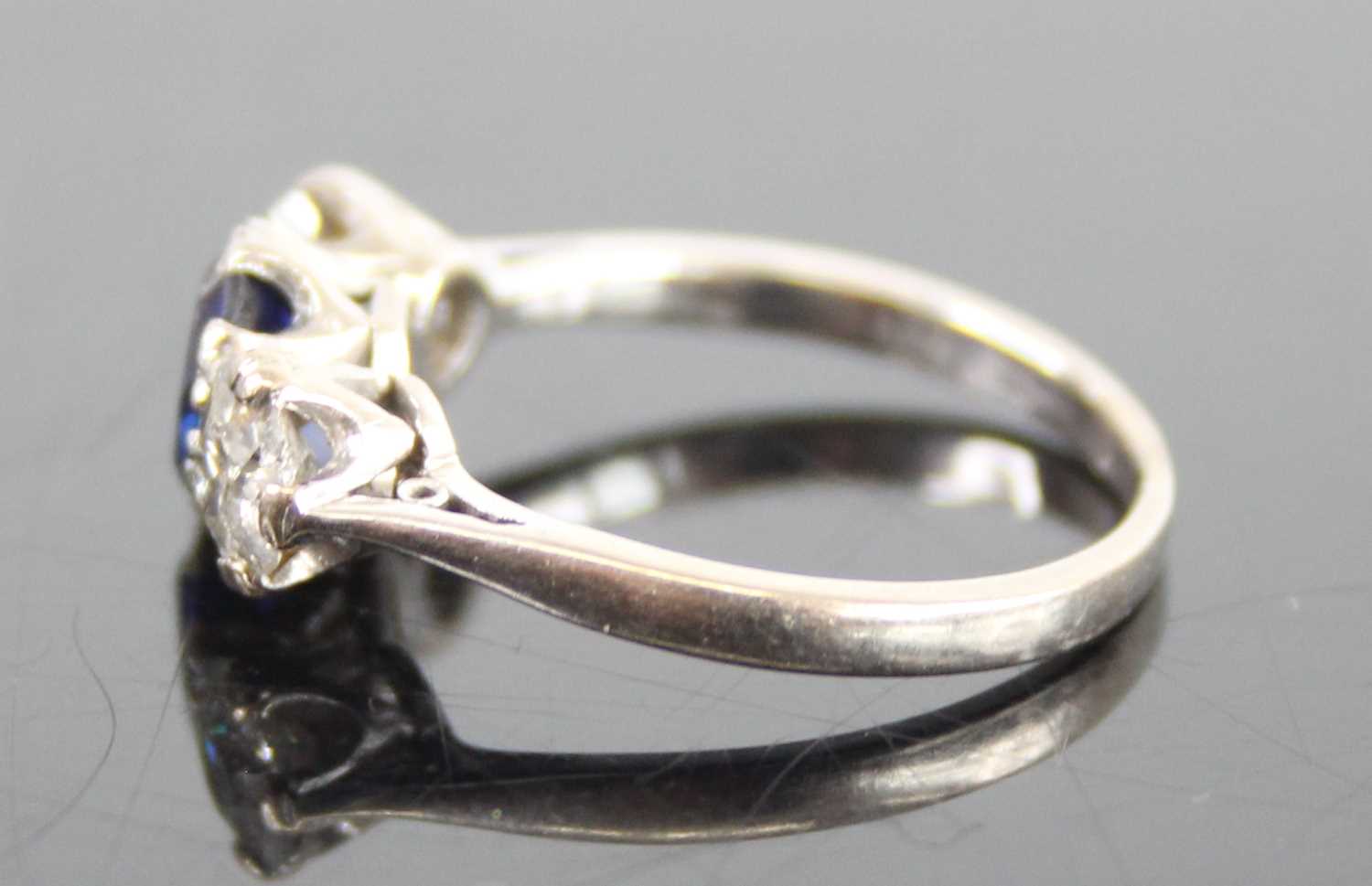 A white metal, sapphire and diamond three-stone ring, featuring a centre oval sapphire with an Old - Image 5 of 7