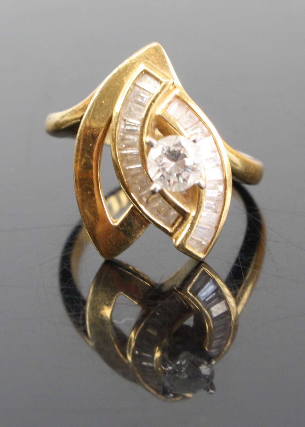 A modern 18ct gold diamond dress ring arranged as a four claw set brilliant, weighing approx 0.3ct