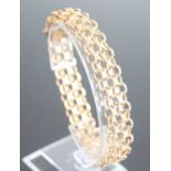 A 9ct yellow gold fancy openwork cross and oval link bracelet with box clasp and 2 figure of 8