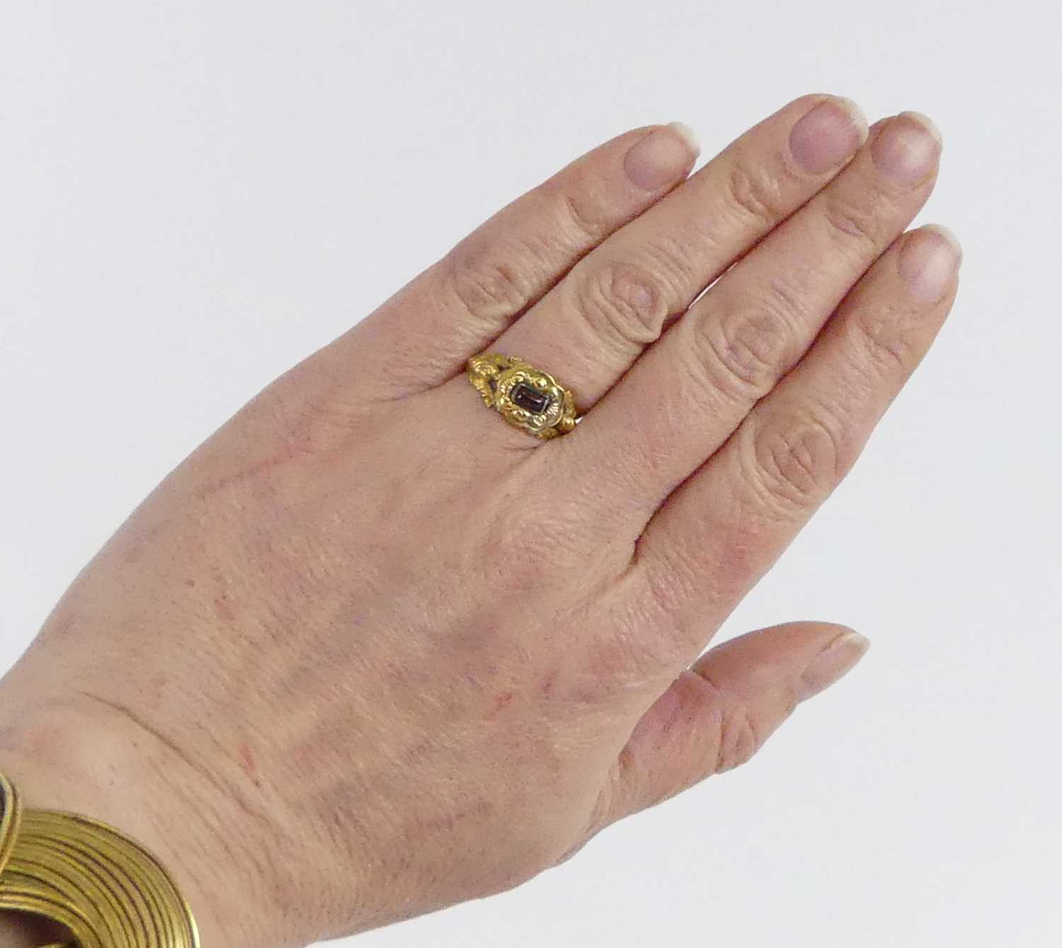 A yellow metal 19th century memorial ring, having a 4.2mm x 2.7mm rectangular garnet cabochon within - Image 6 of 6