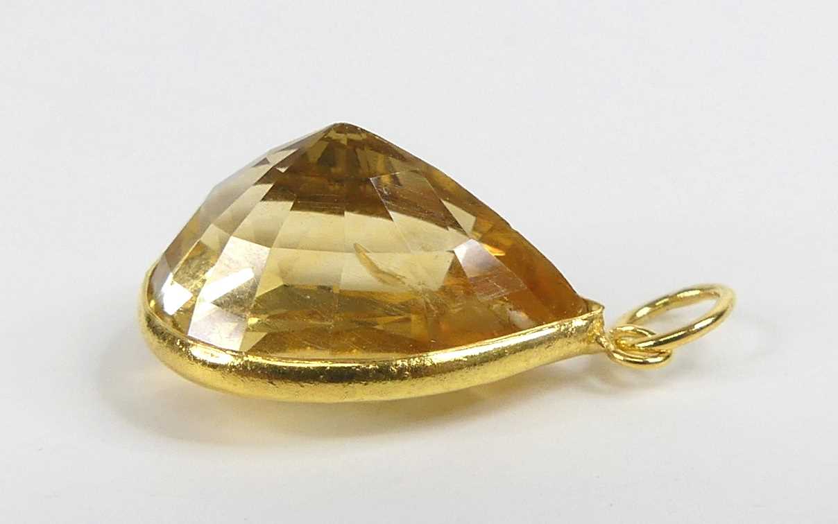 A yellow metal citrine pendant, having a pear cut citrine in a bezel setting, citrine dimensions - Image 2 of 3