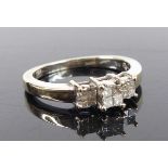 An 18ct white gold diamond tiered quatrefoil cluster ring, featuring three sections of Princess