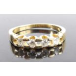 A yellow metal diamond half hoop eternity ring, featuring four round brilliant cut diamonds in